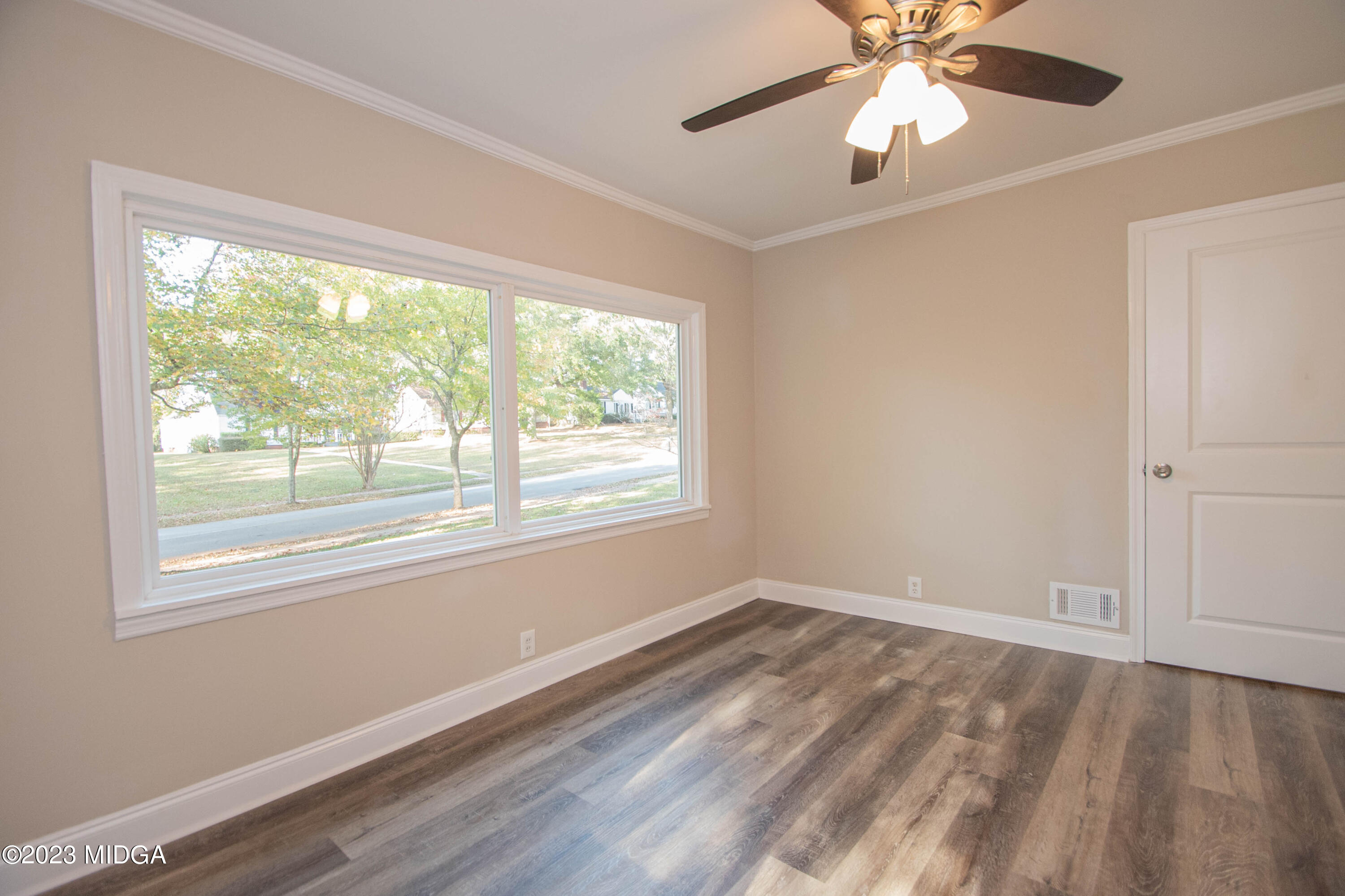225 R Street Northwest Thomaston, GA 30286 - Photo 9 of 22 a view of empty room with wooden floor and fan