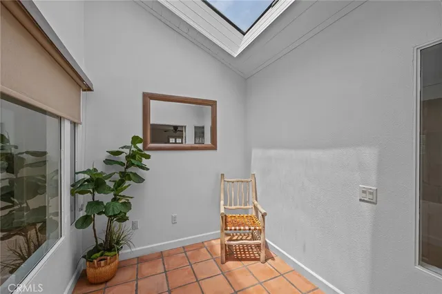 a room with painting and potted plant