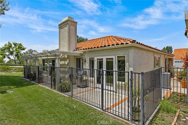 a front view of a house with a garden and plants