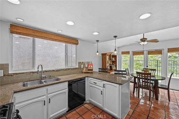 a kitchen with sink stove and cabinets