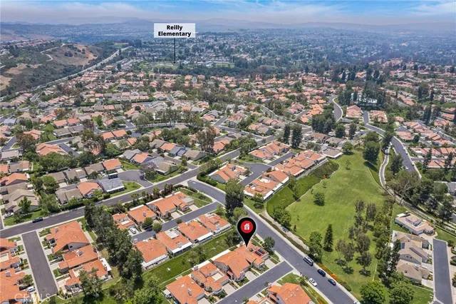 an aerial view of residential houses with city view