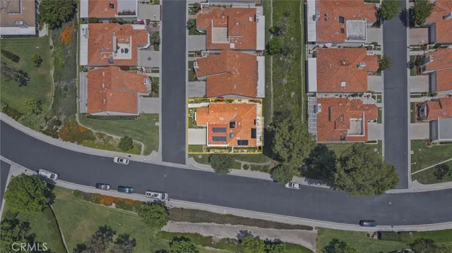 an aerial view of a residential apartment building with a yard and plants