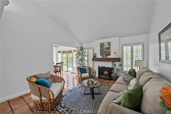 a living room with furniture large window and a fireplace