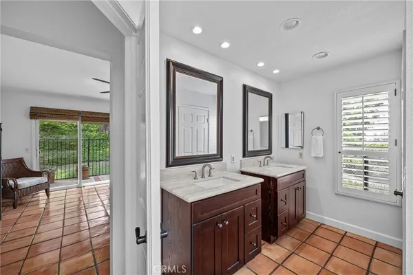 a spacious bathroom with a granite countertop sink and a mirror