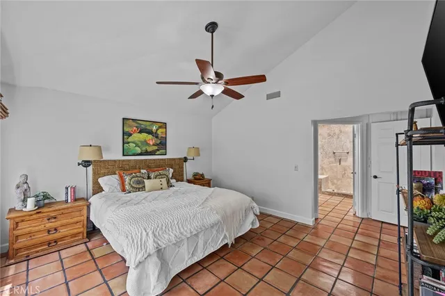 a bedroom with a bed and a ceiling fan