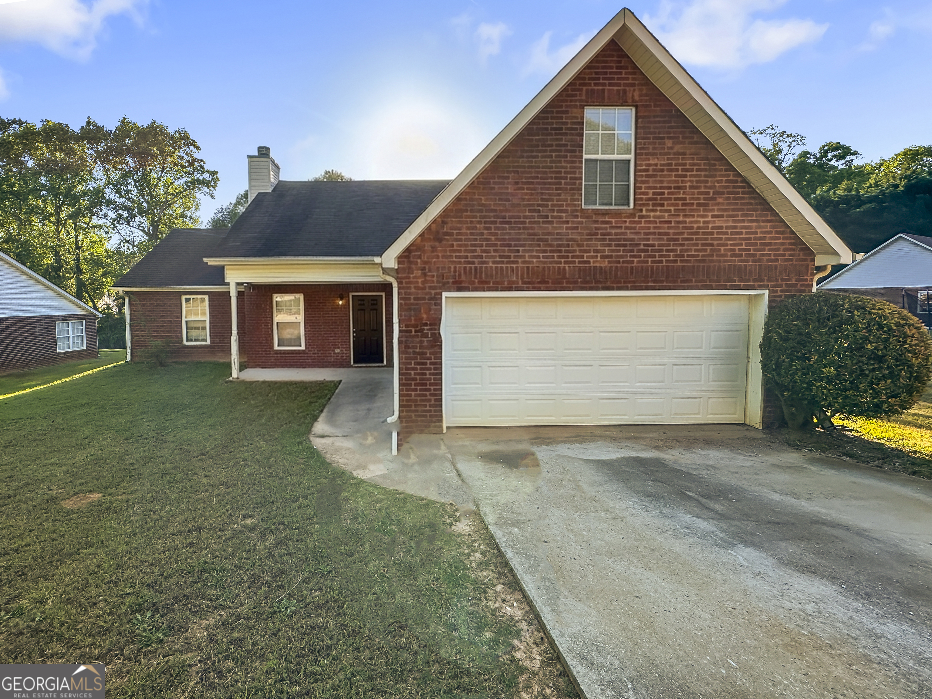 11084 Knotty Pine Place Hampton, GA 30228 - Photo 1 of 18 a front view of a house with a yard and garage