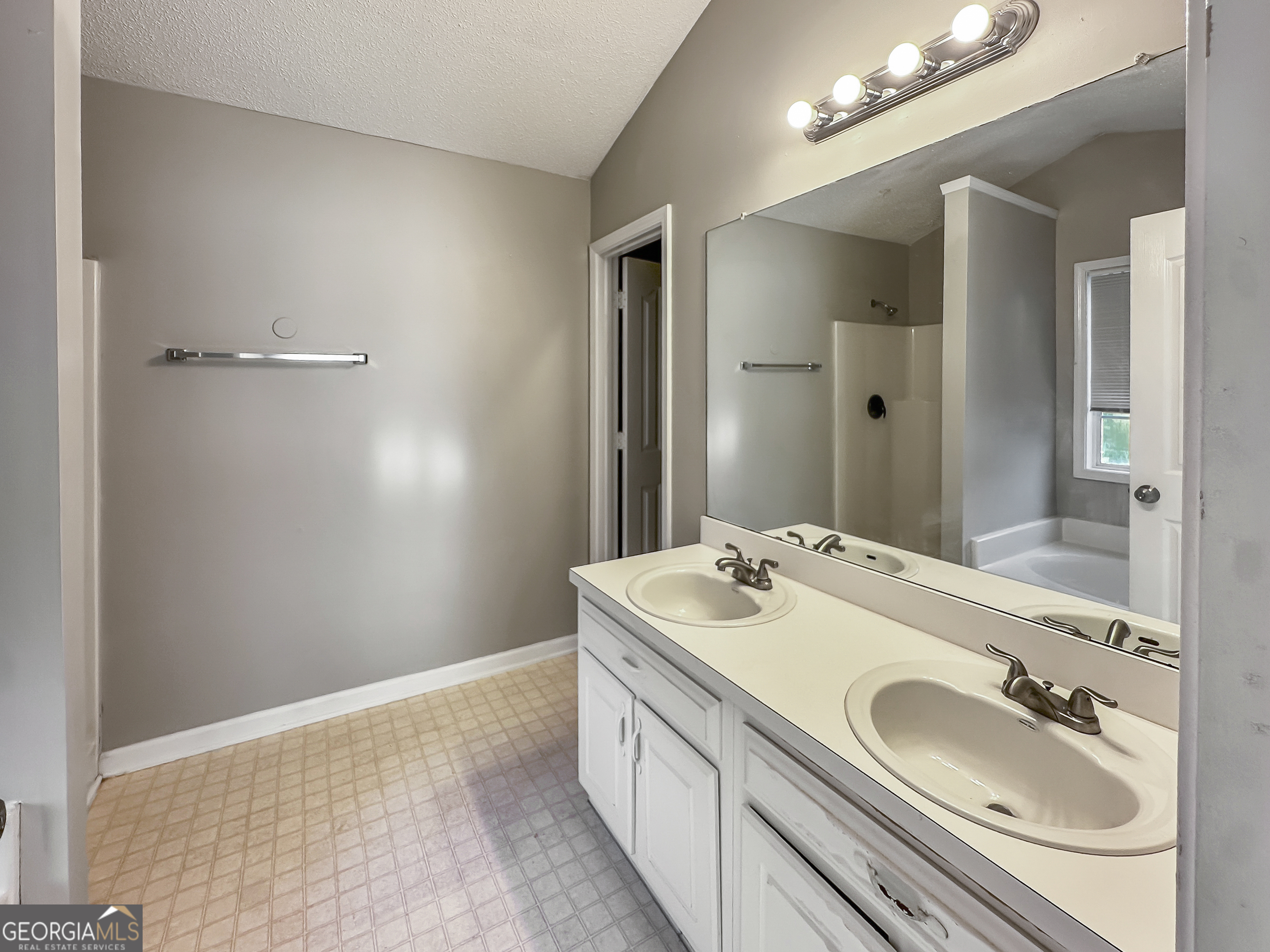 11084 Knotty Pine Place Hampton, GA 30228 - Photo 12 of 18 a bathroom with a sink a toilet and mirror