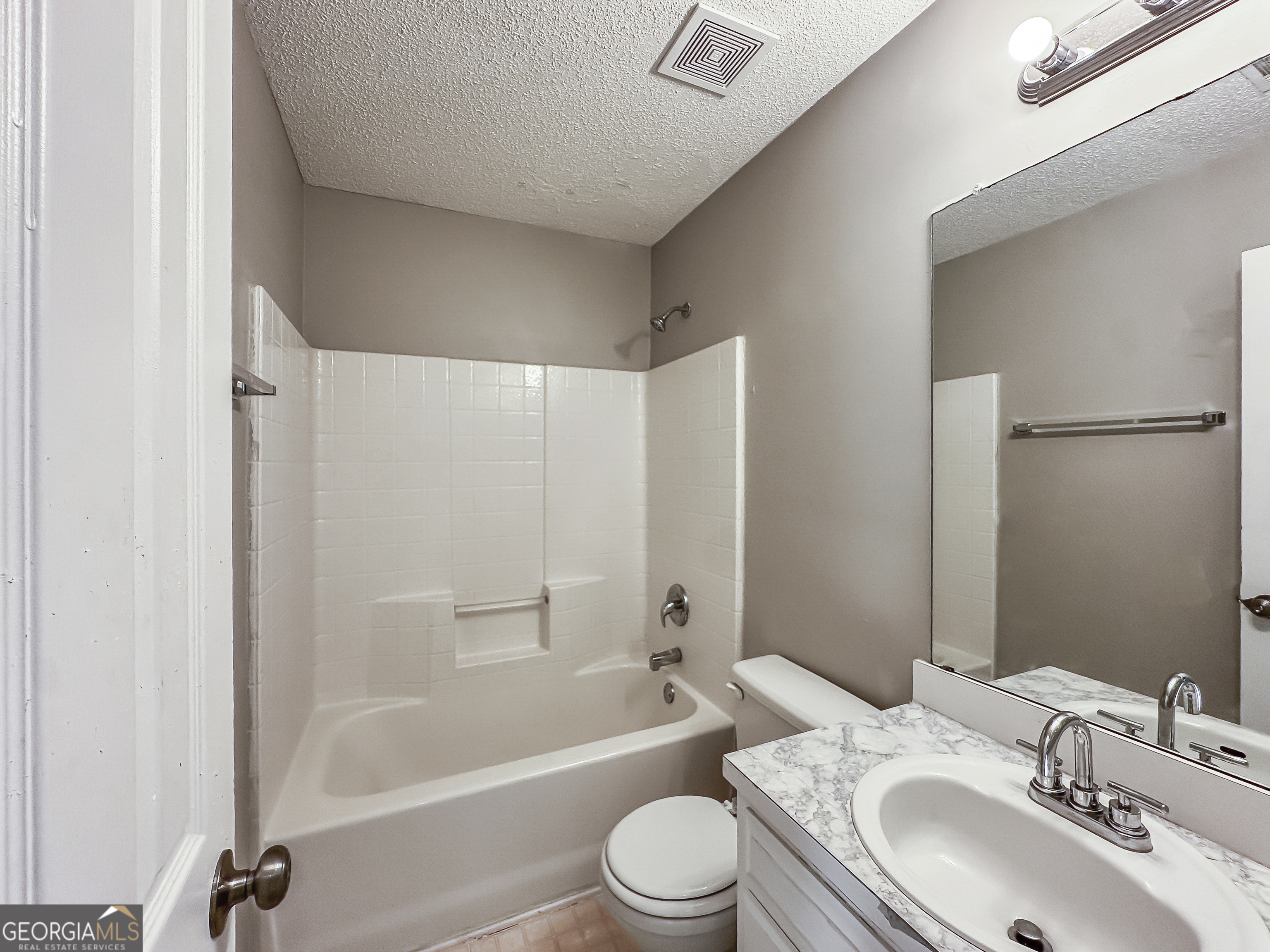 11084 Knotty Pine Place Hampton, GA 30228 - Photo 15 of 18 a bathroom with a toilet a sink and a bathtub