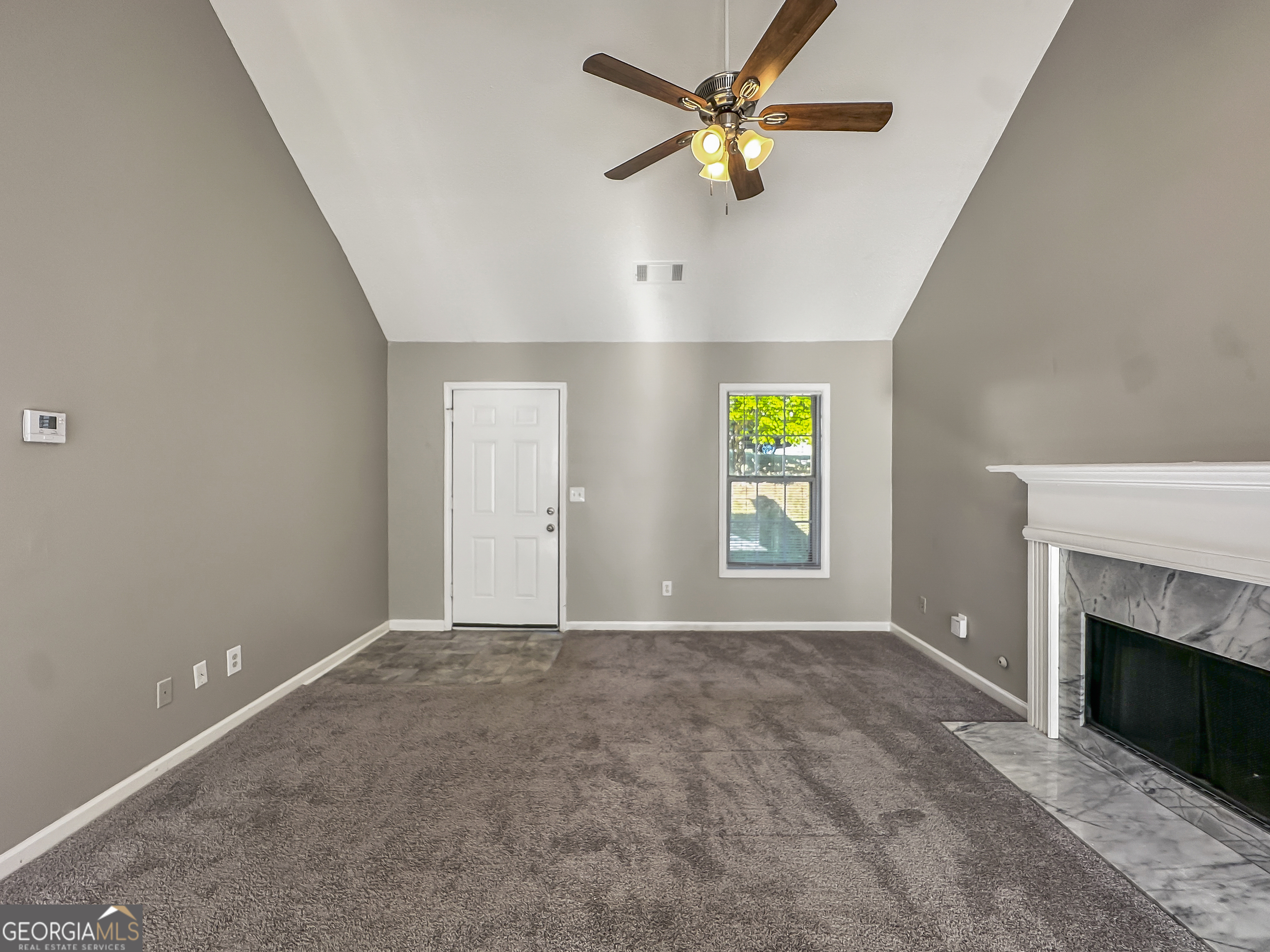 11084 Knotty Pine Place Hampton, GA 30228 - Photo 4 of 18 a view of an empty room with a window and a fireplace