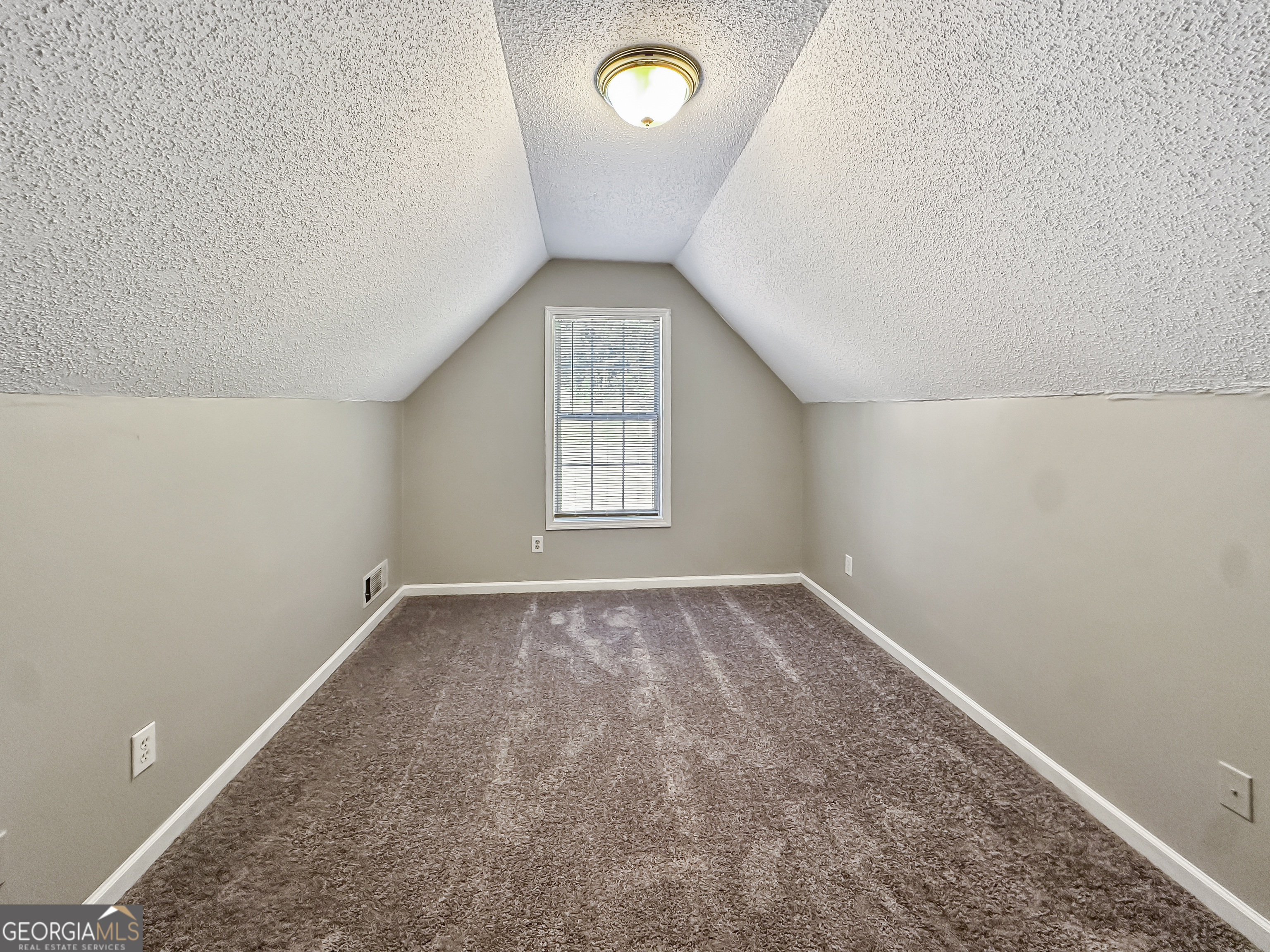 11084 Knotty Pine Place Hampton, GA 30228 - Photo 9 of 18 an empty room with a window