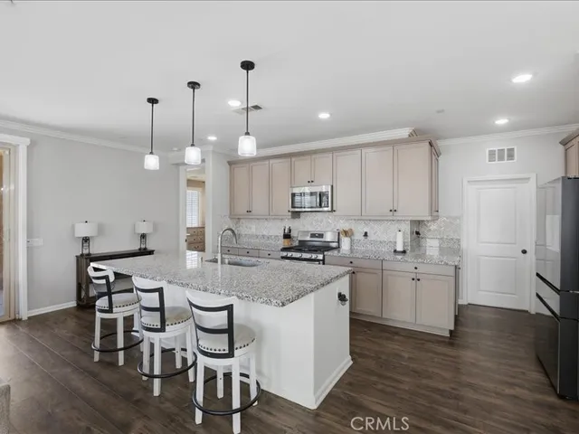 a kitchen with sink cabinets and wooden floor