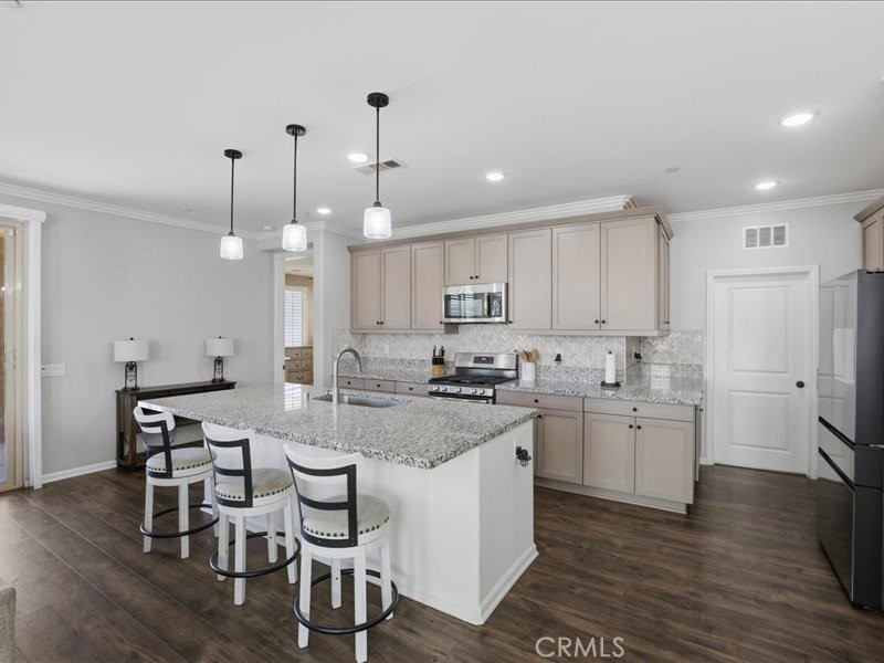 1569 Taurus Lane Beaumont, CA 92223 - Photo 11 of 33 a kitchen with sink cabinets and wooden floor