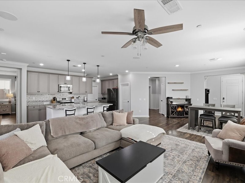 1569 Taurus Lane Beaumont, CA 92223 - Photo 13 of 33 a living room with furniture kitchen view and a wooden floor