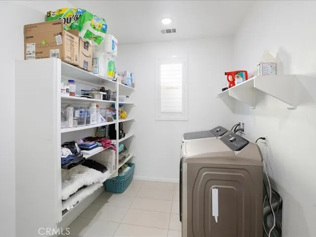 a view of storage and utility room with washer and dryer