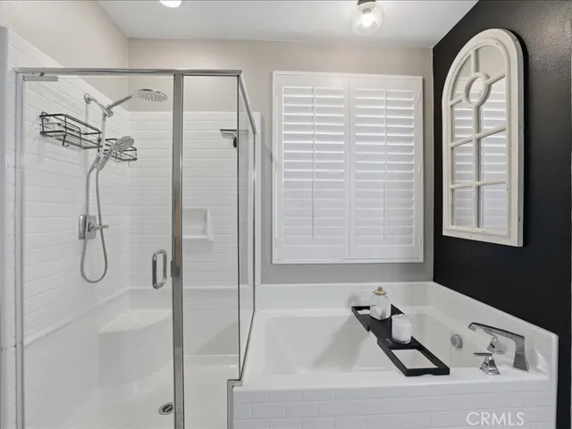 a bathroom with a bathtub and a shower