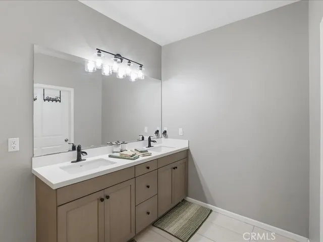 a bathroom with a double vanity sink and a mirror