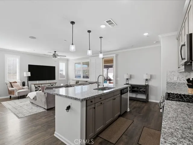 a kitchen with stainless steel appliances kitchen island granite countertop a sink and a stove