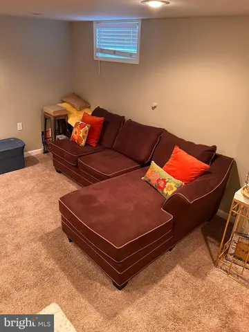 a backyard of a house with furniture and a rug