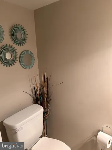 a white toilet sitting next to a bathroom sink and vanity