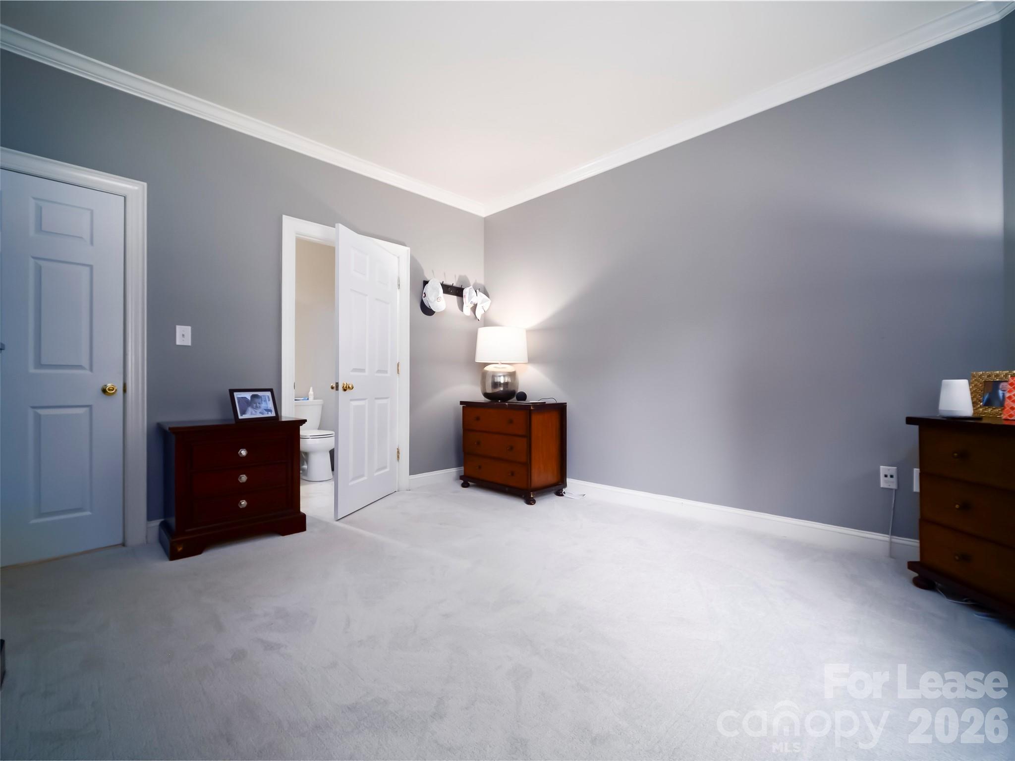 5609 Fairview Road Charlotte, NC 28209 - Photo 13 of 34 a spacious bedroom with a bed and a table