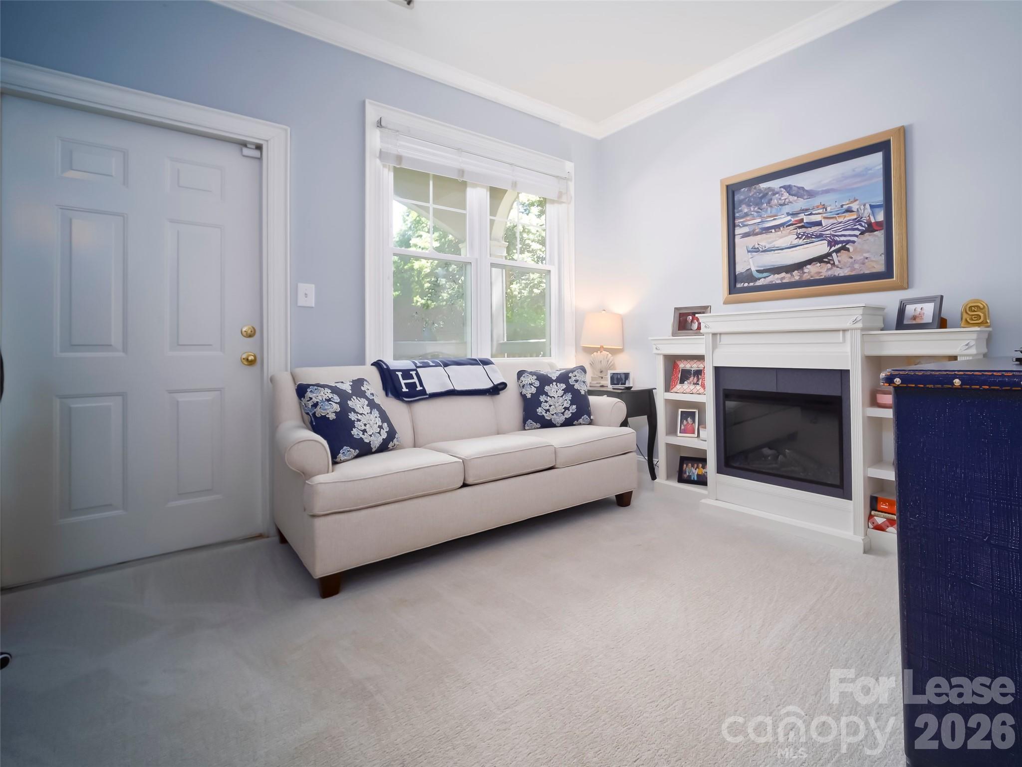 5609 Fairview Road Charlotte, NC 28209 - Photo 19 of 34 a living room with furniture a window and a fireplace