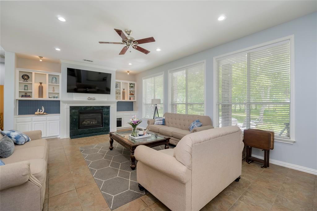 135 Kirkpatrick Road Ennis, TX 75119 - Photo 12 of 40 a living room with furniture fireplace and a flat screen tv