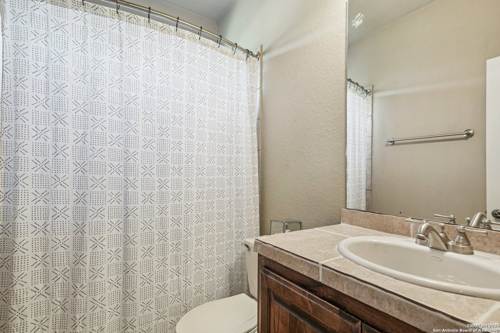 718 Ruidosa Downs Helotes, TX 78023 - Photo 24 of 50 a bathroom with a granite countertop sink toilet and a mirror