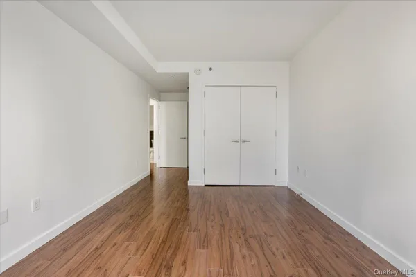 a view of a room with wooden floor