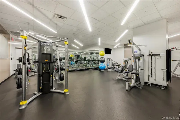 a living room with furniture a rug and a projector