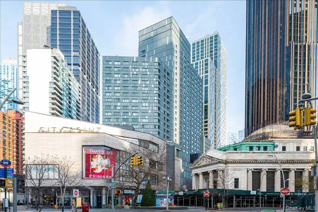 a view of a swimming pool with sitting area and slide