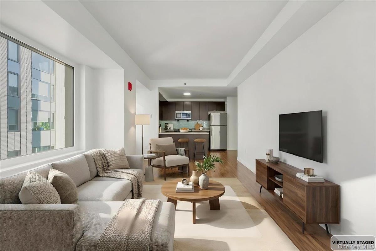 70 Fleet Street, Unit 19F Brooklyn, NY 11201 - Photo 6 of 32 a living room with furniture and a flat screen tv