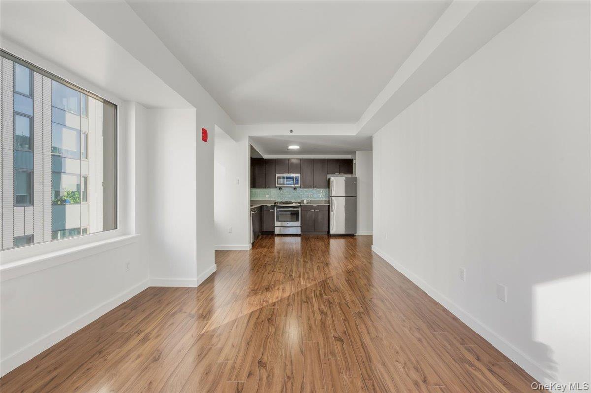 70 Fleet Street, Unit 19F Brooklyn, NY 11201 - Photo 7 of 32 a view of a kitchen with wooden floor and a window