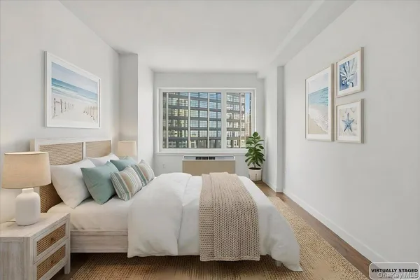 a bed room with a bed and a large window