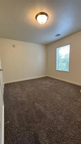 a bathroom with a granite countertop sink a toilet and a mirror