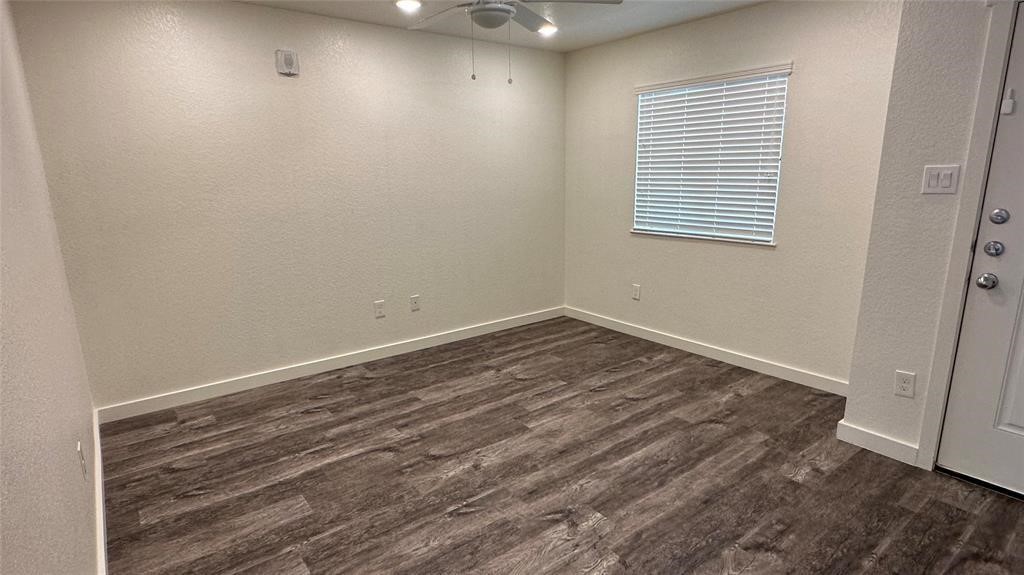 21155 Gosling Road, Unit 38C Spring, TX 77388 - Photo 17 of 21 an empty room with wooden floor and windows