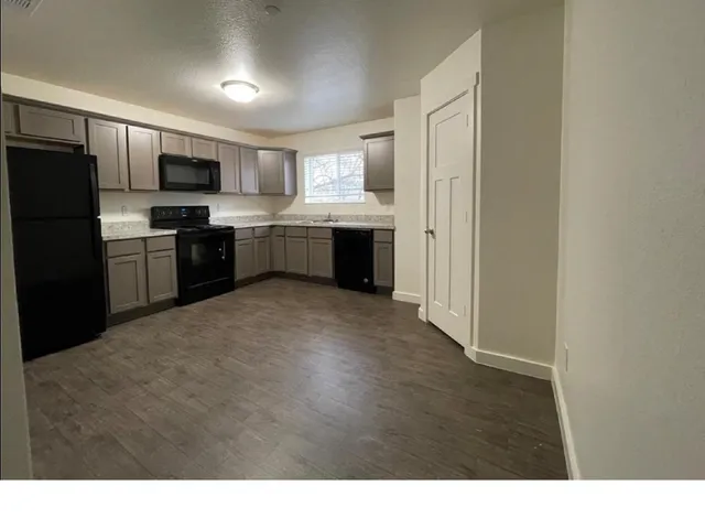 a kitchen with refrigerator cabinets and stainless steel appliances