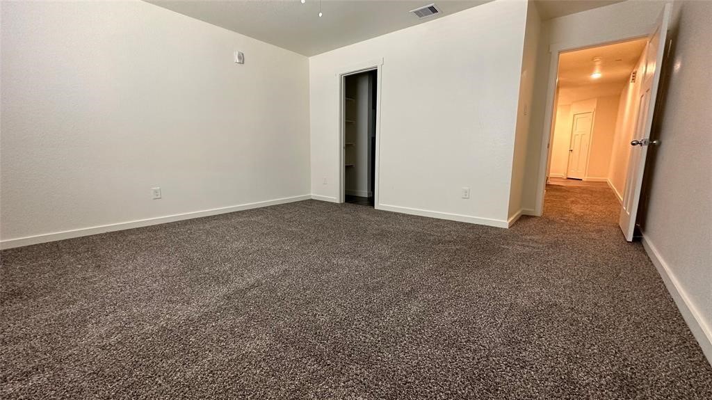 21155 Gosling Road, Unit 38C Spring, TX 77388 - Photo 10 of 21 an empty room with closet and mirror