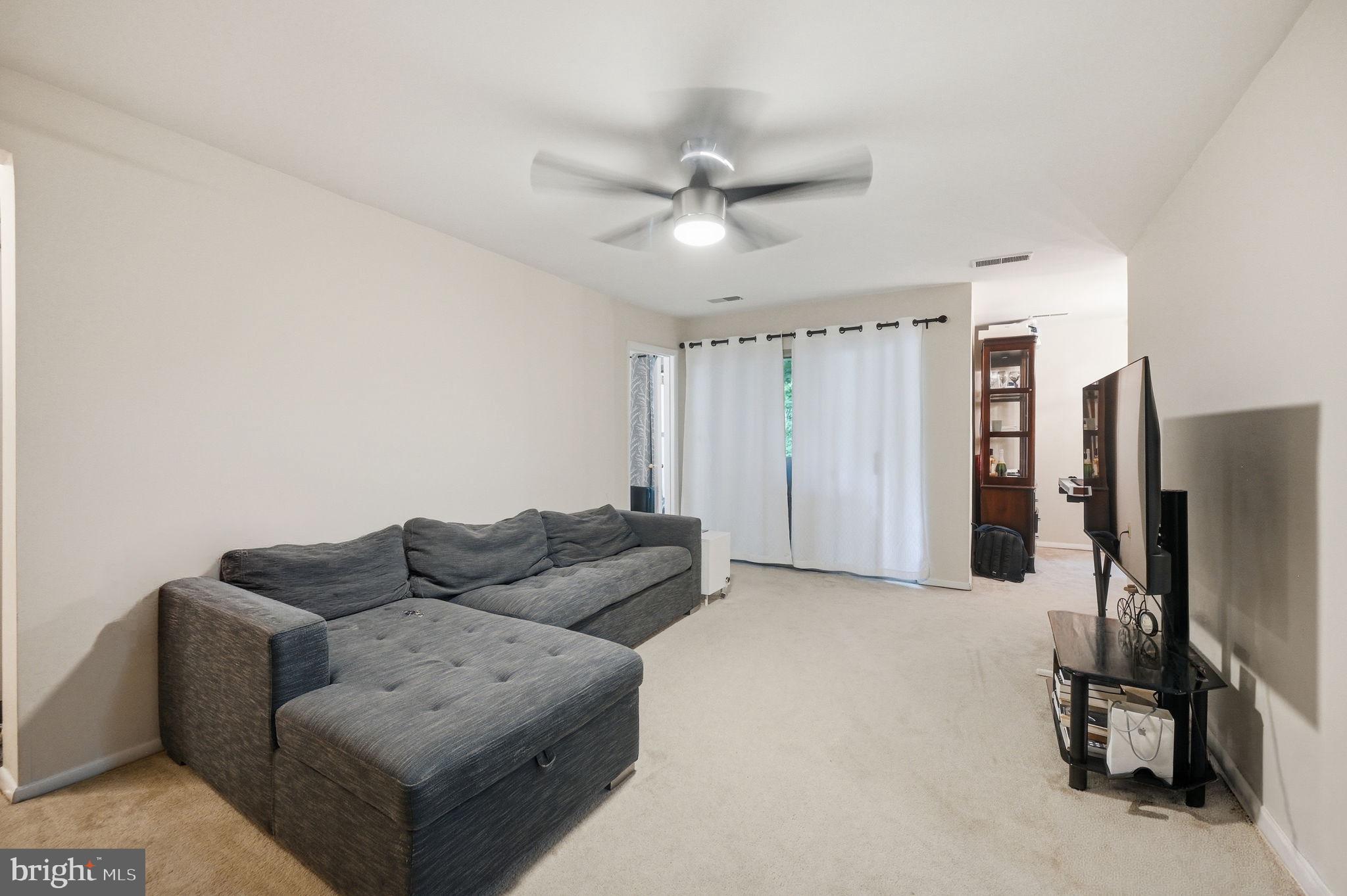3366 Woodburn Road, Unit 23 Annandale, VA 22003 - Photo 6 of 16 a living room with furniture ceiling fan