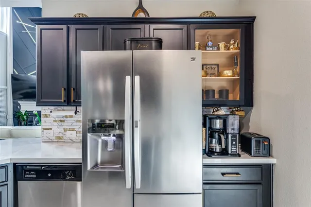 a kitchen with stainless steel appliances a refrigerator and cabinets