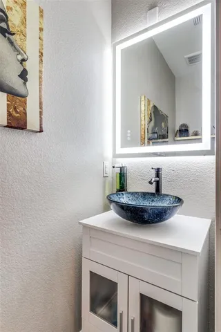 a room with a sink and a mirror