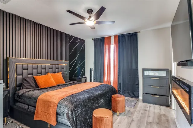 a bedroom with a large bed and a tv