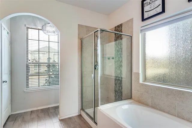 a bathroom with a tub and shower