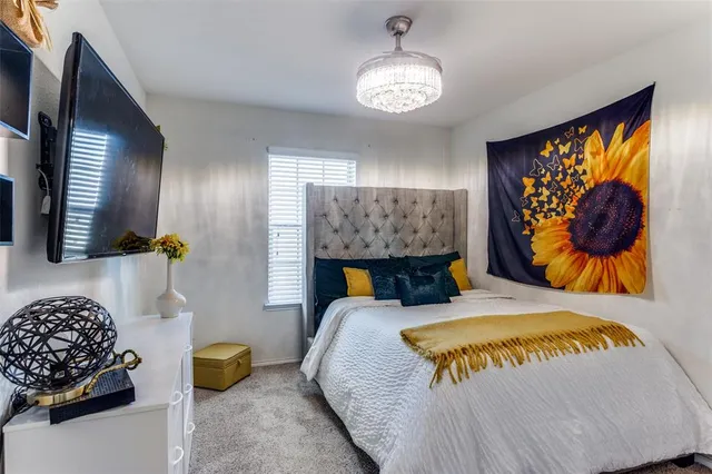 a bed sitting in a bedroom next to a lamp