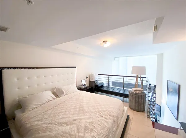 a bedroom with bed and a lamp