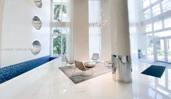 a living room with furniture and a large window