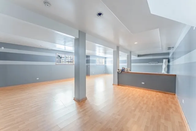 a view of an empty room with a cabinet and mirrors