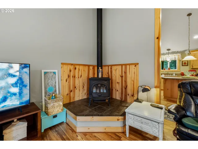 a living room with furniture a flat screen tv and a floor to ceiling window