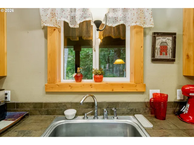 a bedroom with a bed and large windows