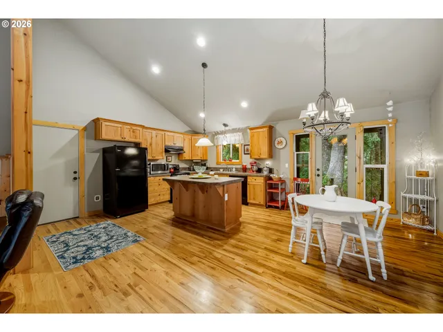 a living room with stainless steel appliances kitchen island granite countertop a kitchen view and living room view