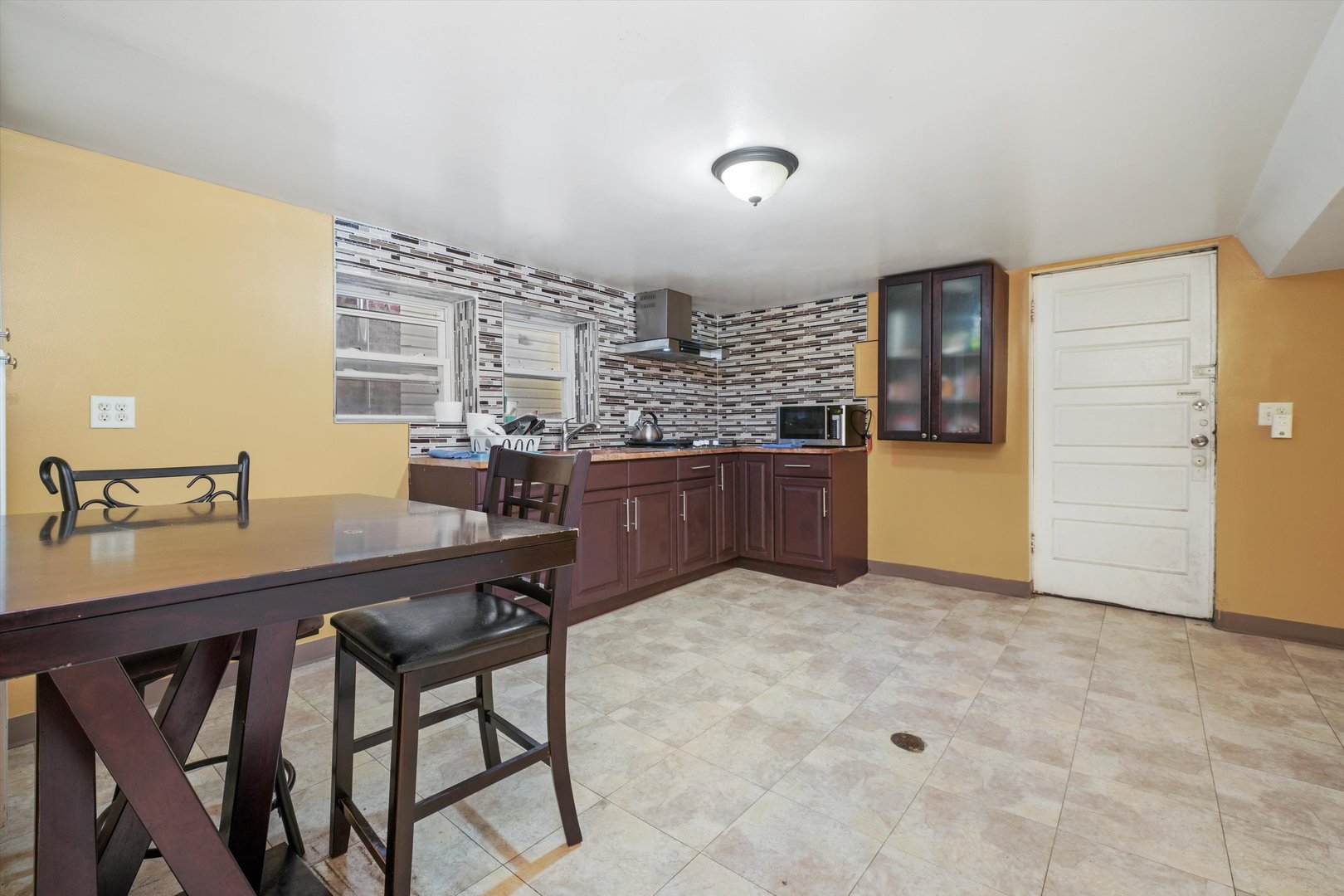 Undisclosed Address Chicago, IL 60641 - Photo 13 of 32 a kitchen with a table and chairs in it